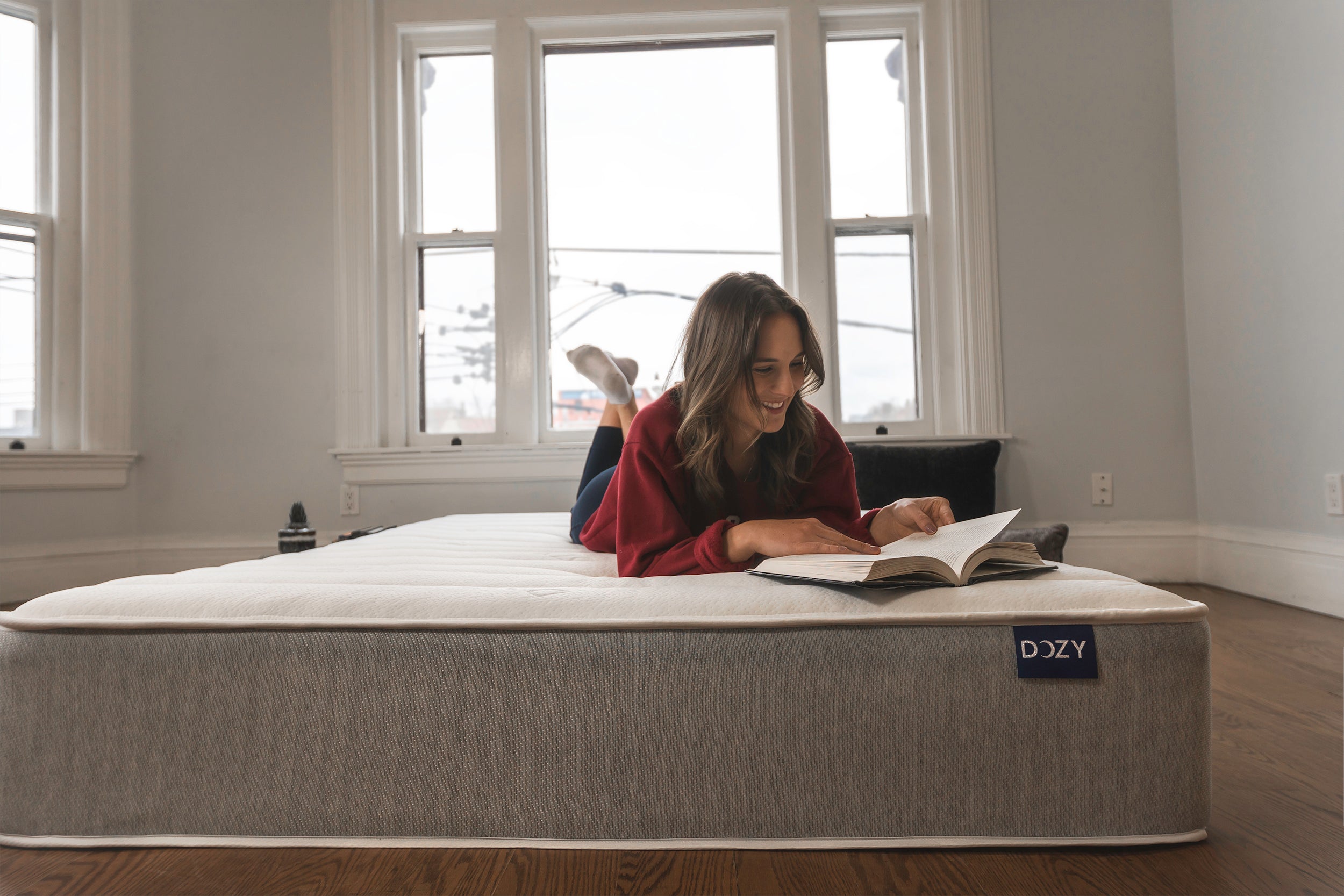Girl reading a book on a Dozy mattress