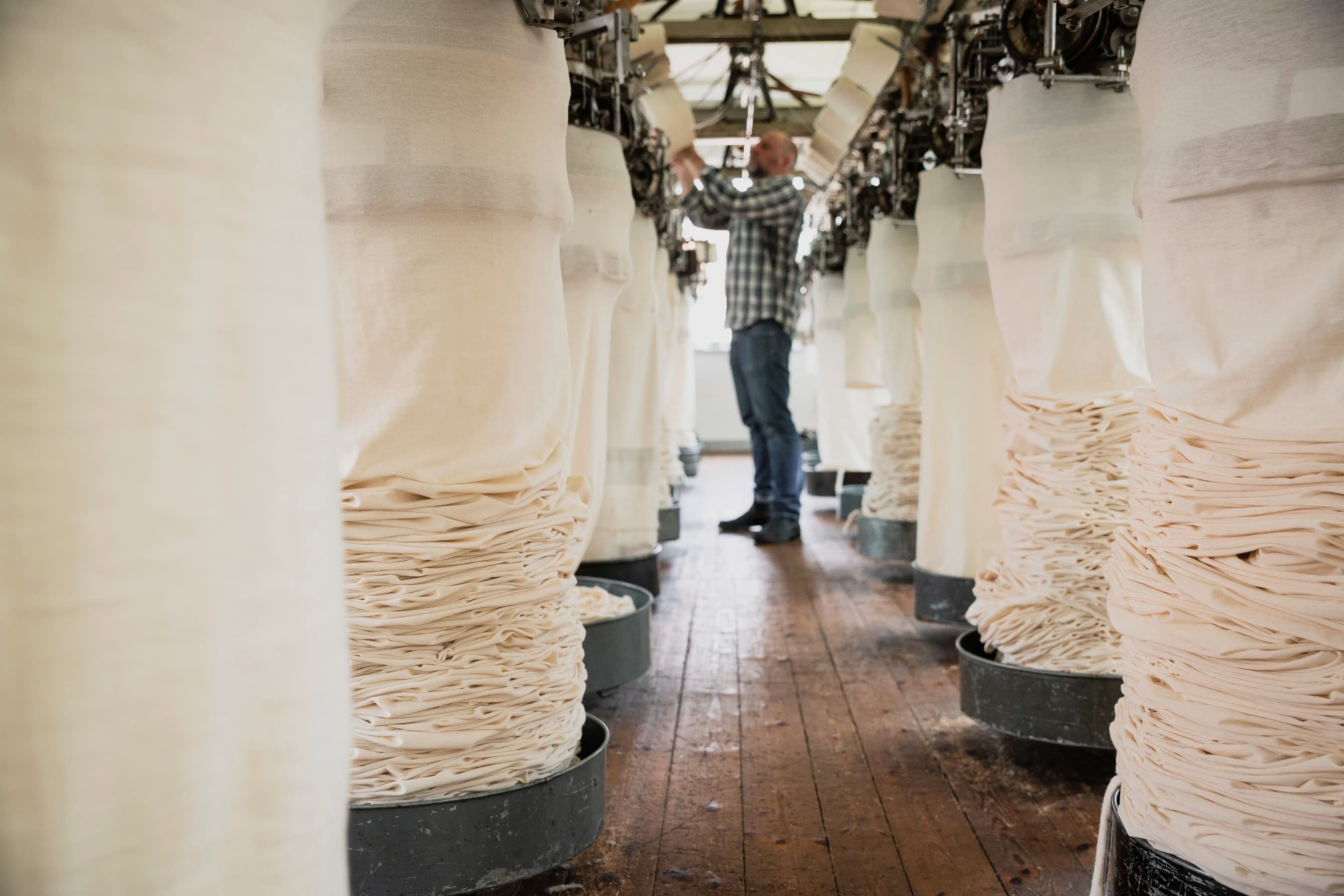 Worker adjusting thread on a circular knitting machine